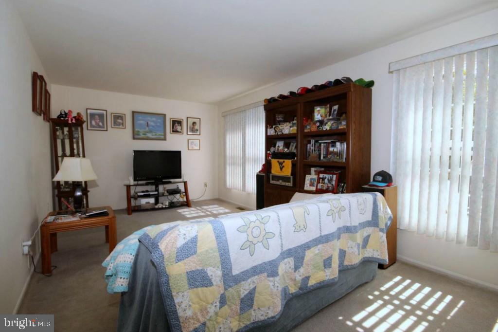 228 Schooner Road Manahawkin, NJ 08050 - Photo 10 of 19 a bedroom with furniture and a flat screen tv