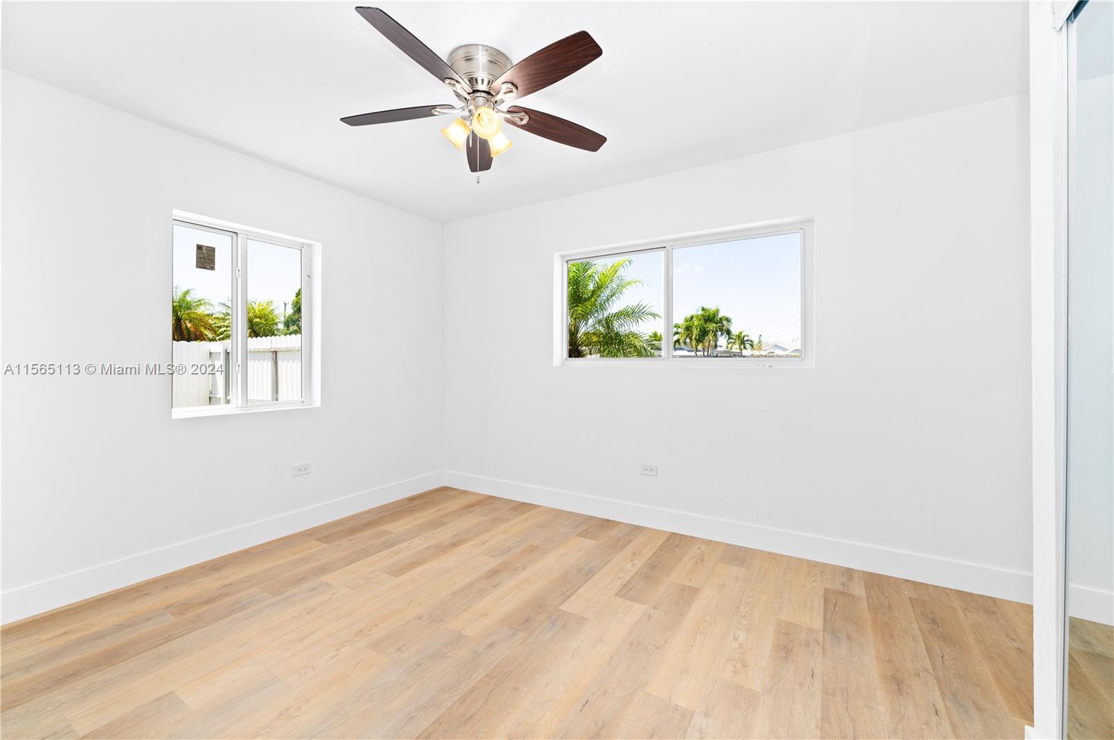 29451 Maine Road Homestead, FL 33033 - Photo 13 of 22 an empty room with a window and a ceiling fan