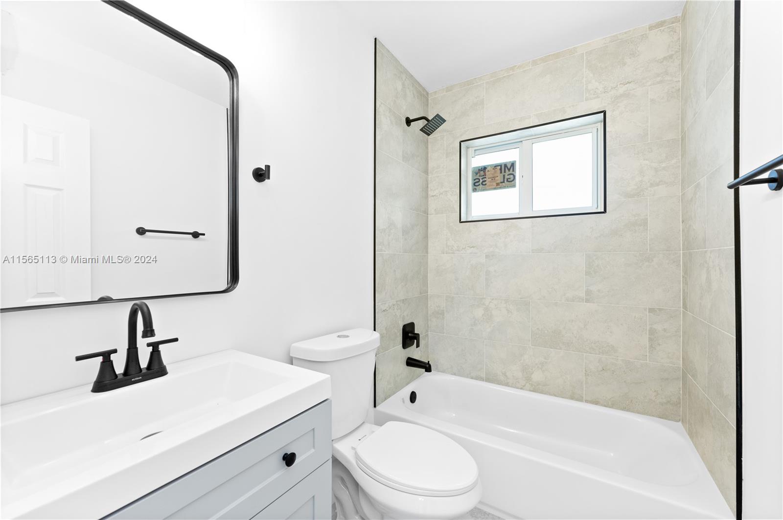 29451 Maine Road Homestead, FL 33033 - Photo 18 of 22 a bathroom with a toilet a sink a mirror and bathtub