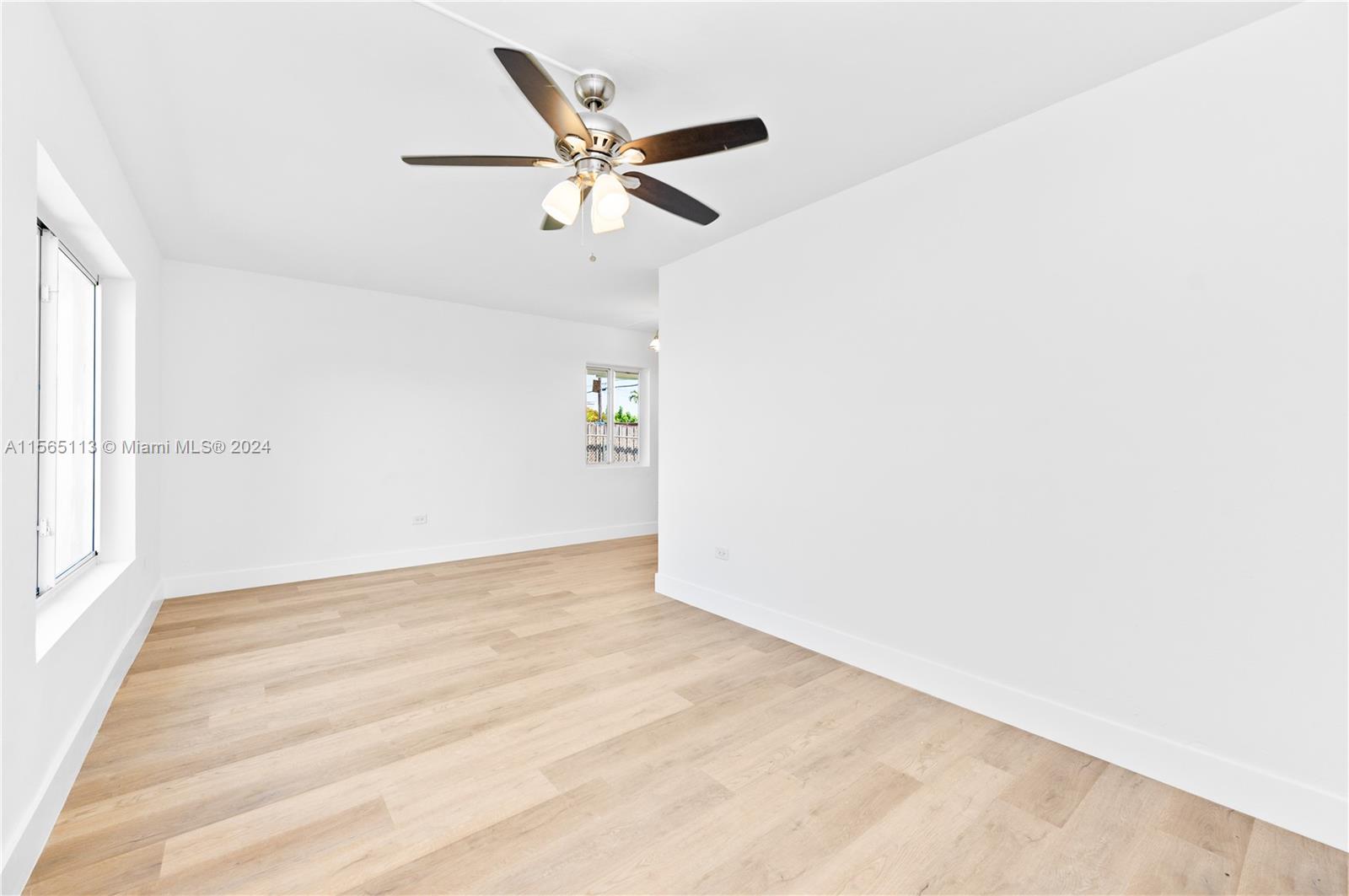 29451 Maine Road Homestead, FL 33033 - Photo 20 of 22 a view of a big room with wooden floor closet and windows
