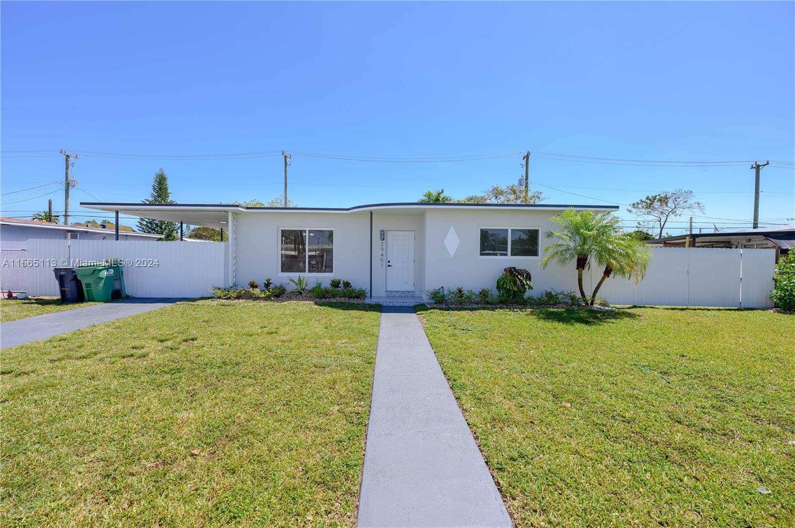 29451 Maine Road Homestead, FL 33033 - Photo 3 of 22 a front view of a house with a yard and garage