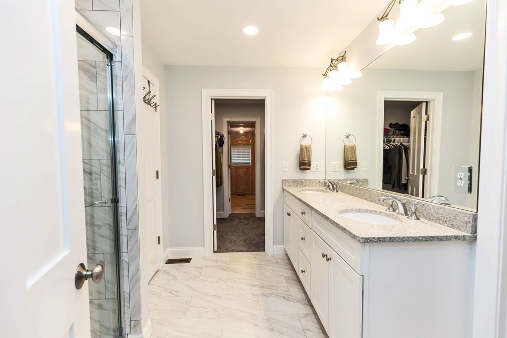 95-1 Lowell Road, Unit 1 Pepperell, MA 01463 - Photo 20 of 36 a spacious bathroom with a granite countertop sink mirror and a