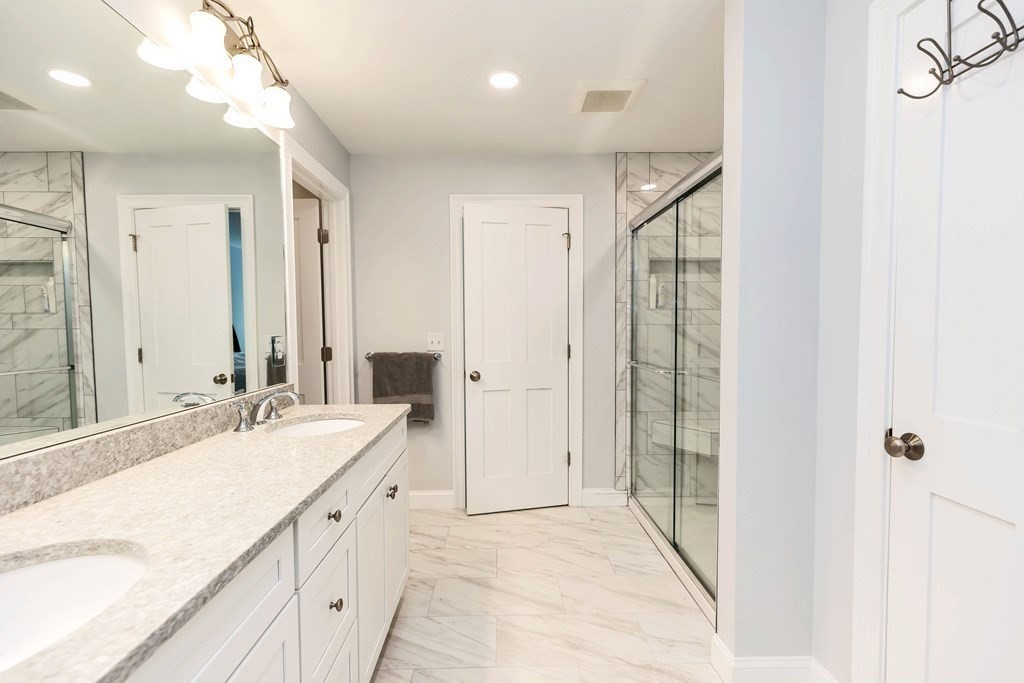95-1 Lowell Road, Unit 1 Pepperell, MA 01463 - Photo 23 of 36 a spacious bathroom with a mirror sink and shower