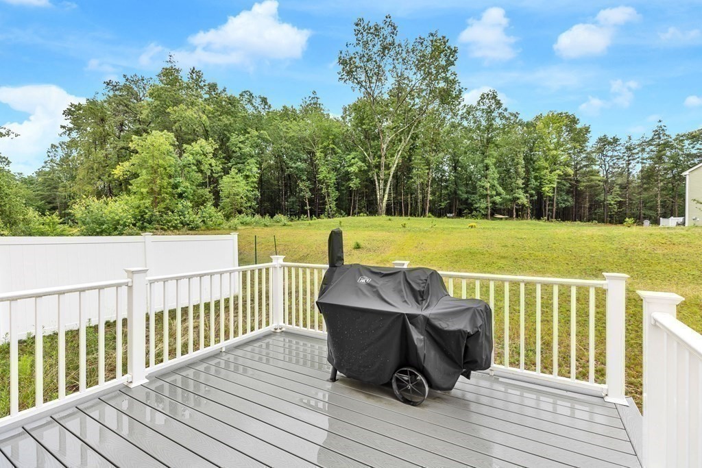95-1 Lowell Road, Unit 1 Pepperell, MA 01463 - Photo 36 of 36 a view of a deck with wooden floor and seating space