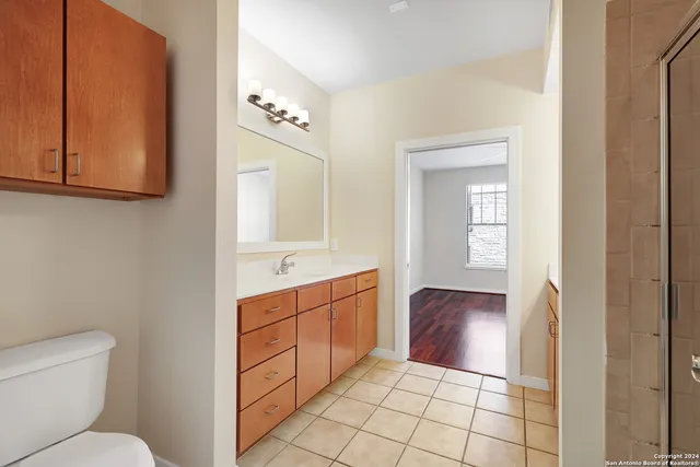 a bathroom with a toilet sink and mirror