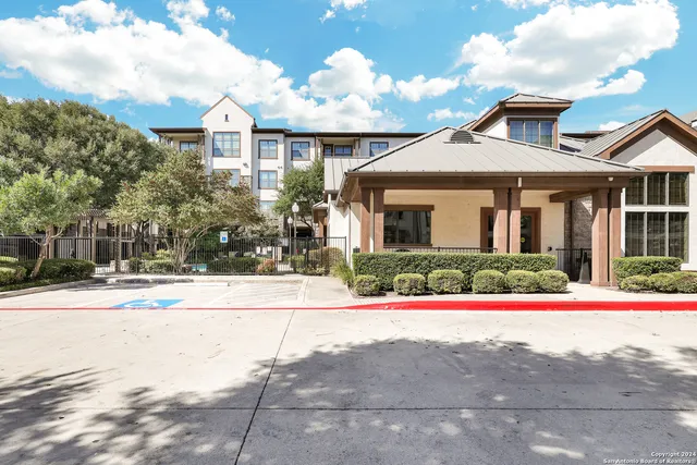 a view of pool with a bench and trees