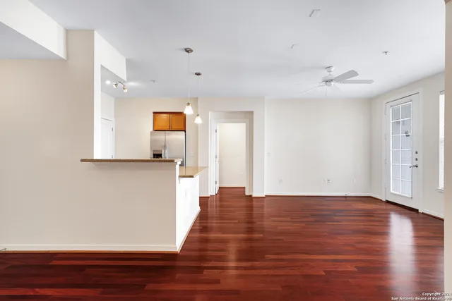 a view of a room with wooden floor and an entryway