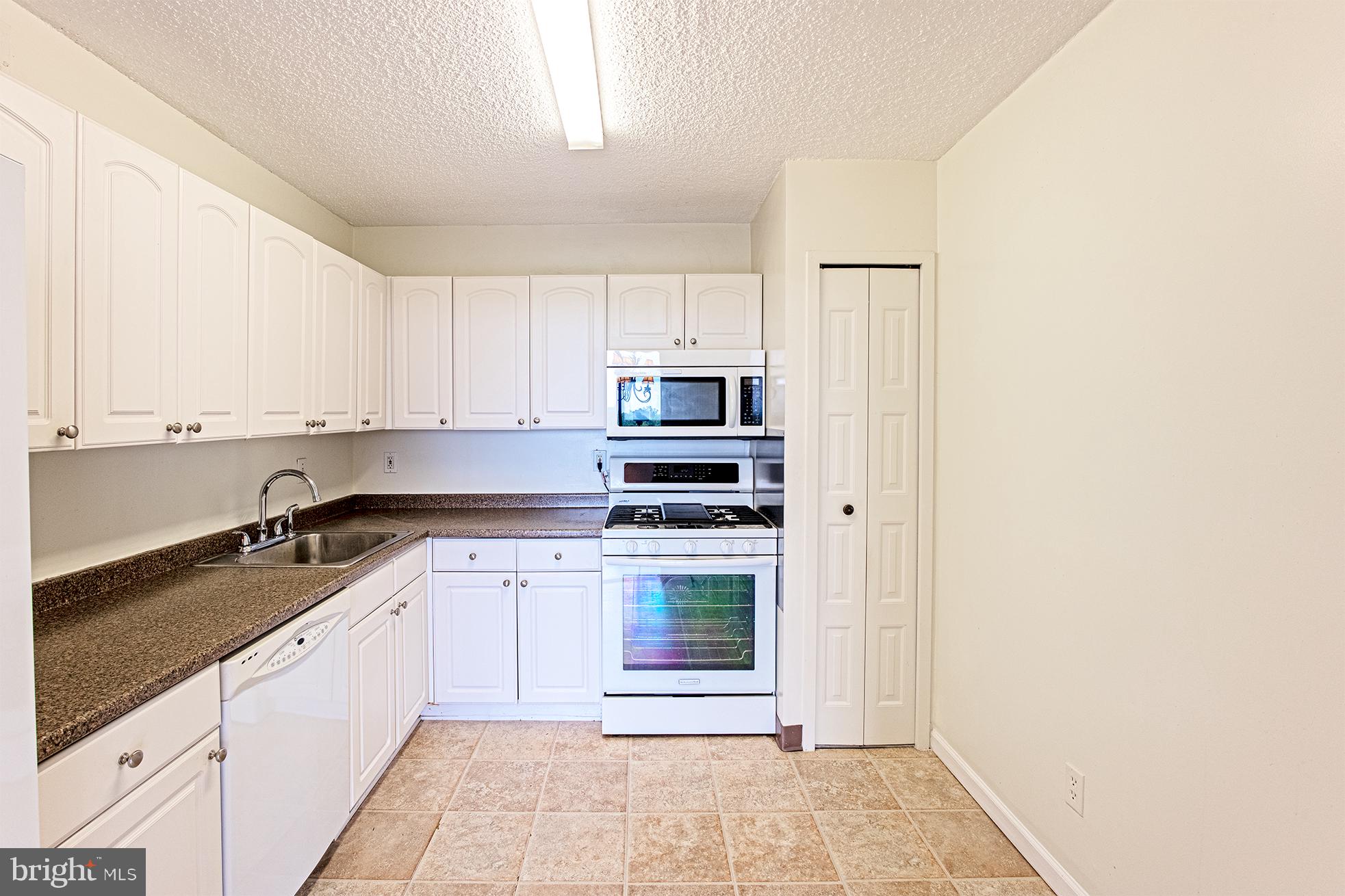 5225 Pooks Hill Road, Unit 721S Bethesda, MD 20814 - Photo 12 of 22 a kitchen with stainless steel appliances granite countertop a stove and a refrigerator