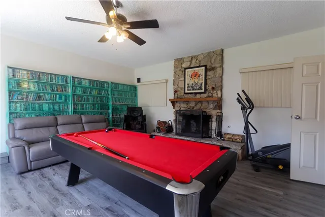 a room with pool table and windows