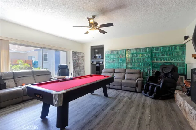 a living room with furniture pool table and a large window