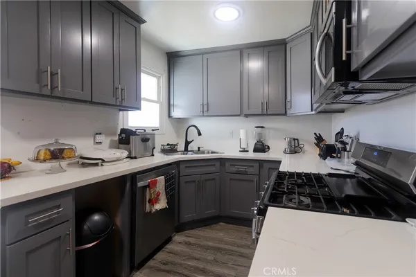 a kitchen with a sink a stove and cabinets