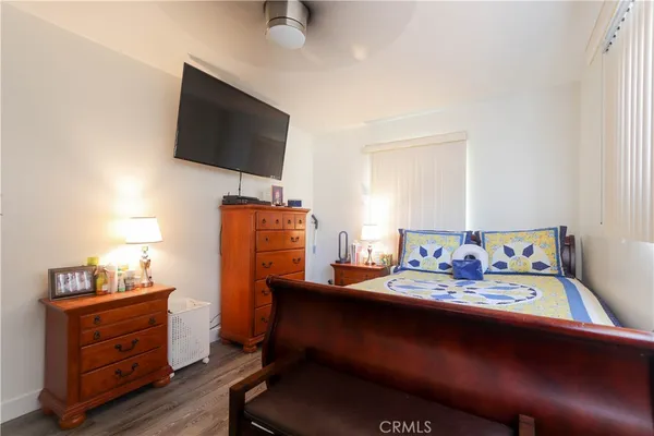 a bedroom with furniture and a flat screen tv