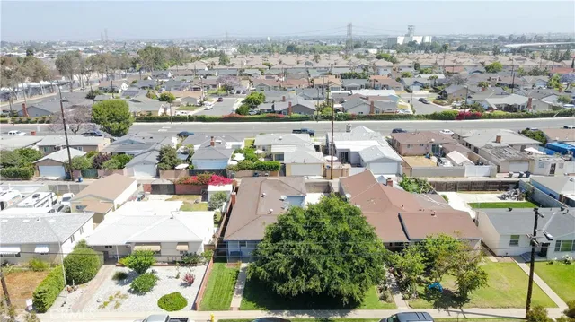an aerial view of a house with a yard and lake view