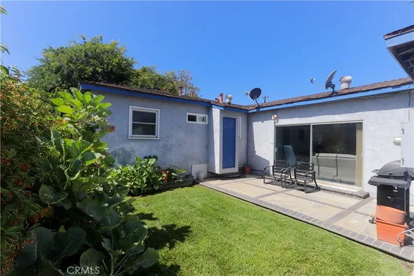 a front view of a house with a yard and seating space