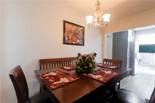 a view of a dining room with furniture and a chandelier