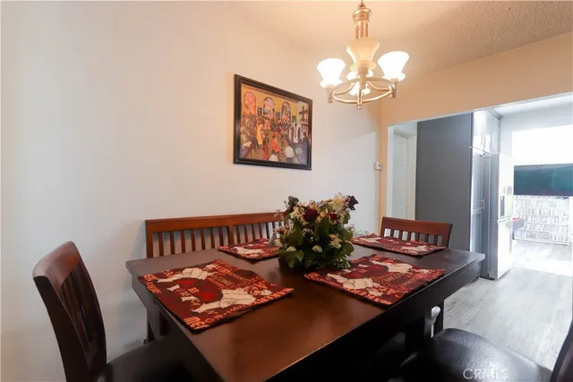 a view of a dining room with furniture and a chandelier