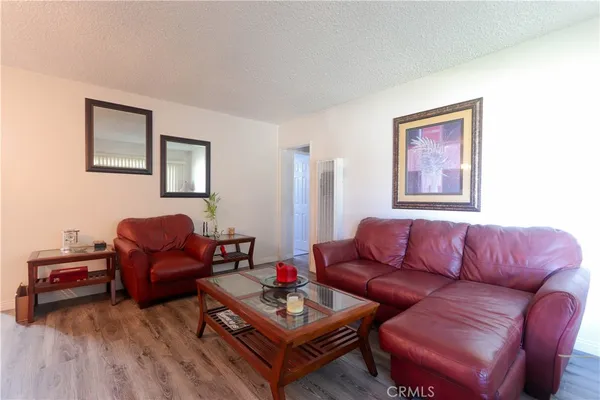 a living room with furniture a couch and wooden floor