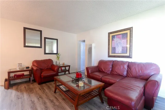 a living room with furniture a couch and wooden floor