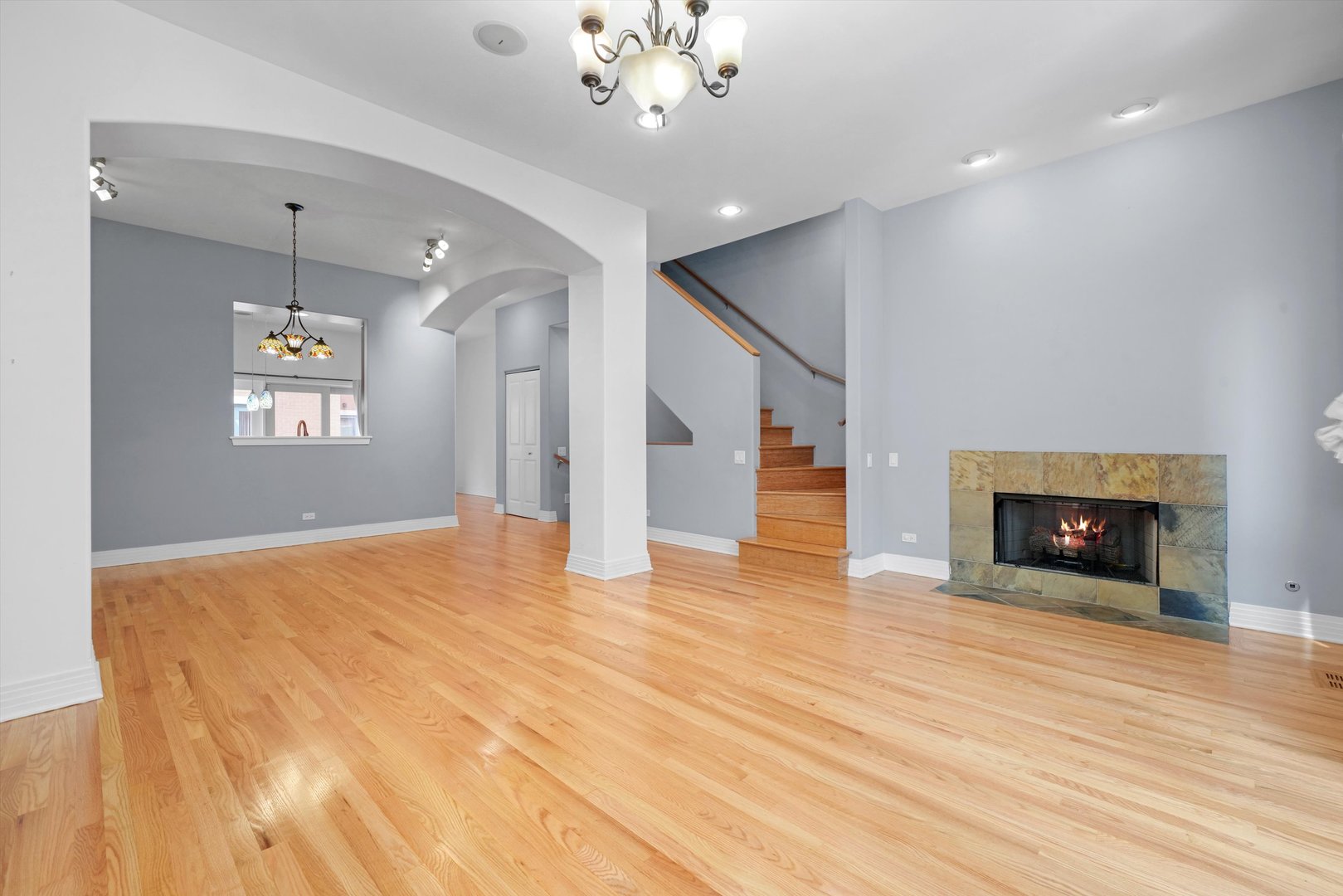 1055 West Monroe Street, Unit A Chicago, IL 60607 - Photo 11 of 28 a view of an empty room with a fireplace and wooden floor