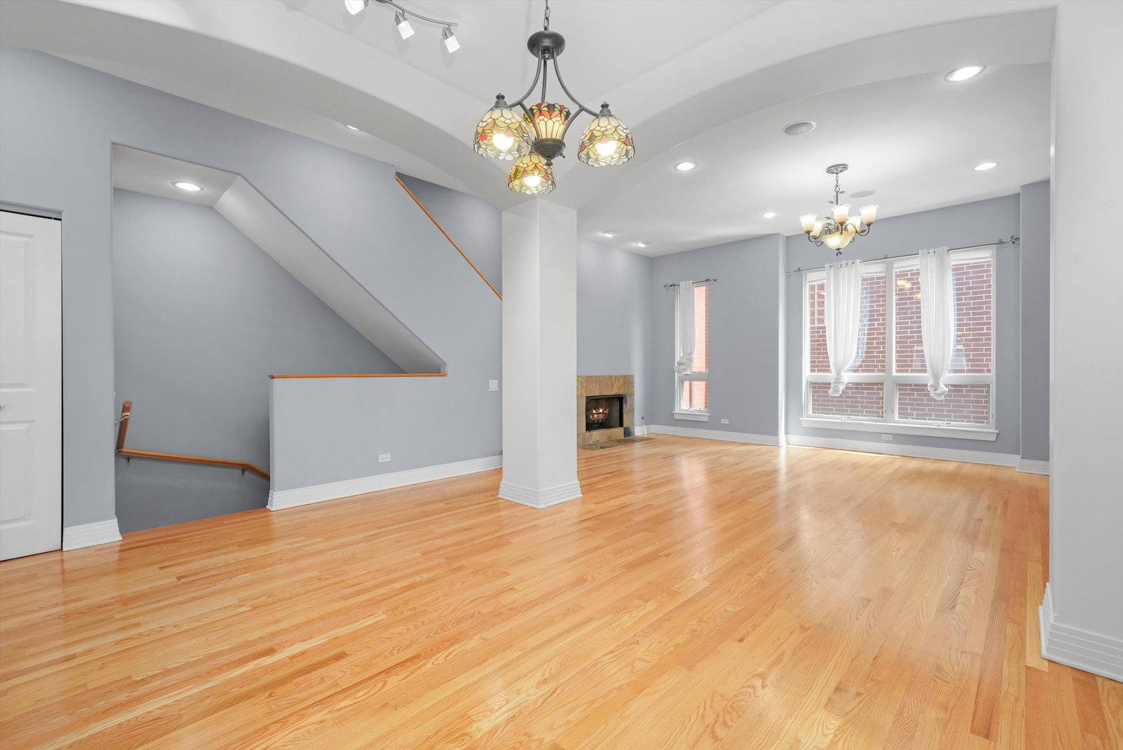 1055 West Monroe Street, Unit A Chicago, IL 60607 - Photo 12 of 28 a view of an empty room with wooden floor and a kitchen