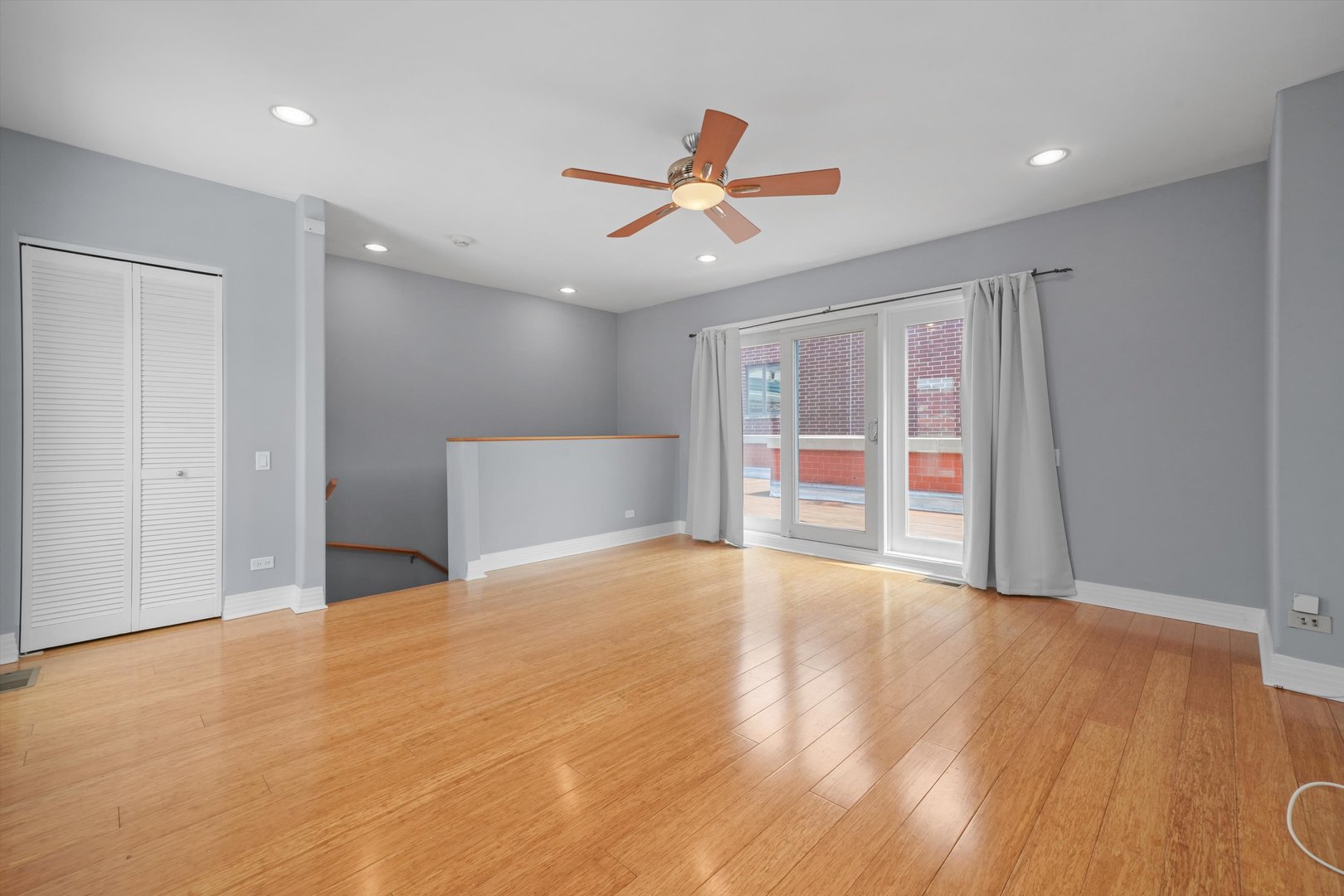 1055 West Monroe Street, Unit A Chicago, IL 60607 - Photo 19 of 28 a view of an empty room with wooden floor and a ceiling fan