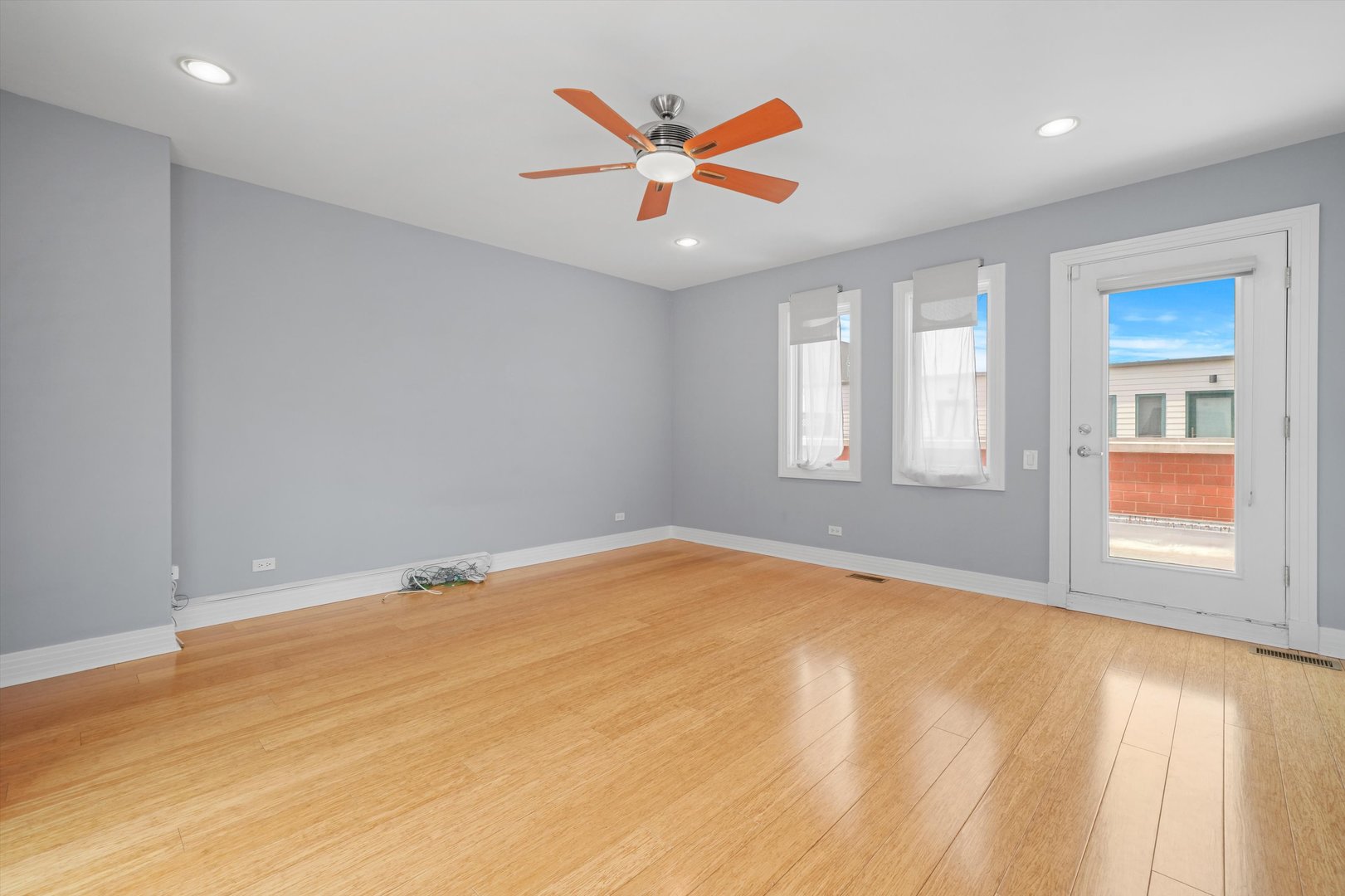 1055 West Monroe Street, Unit A Chicago, IL 60607 - Photo 20 of 28 an empty room with window and ceiling fan