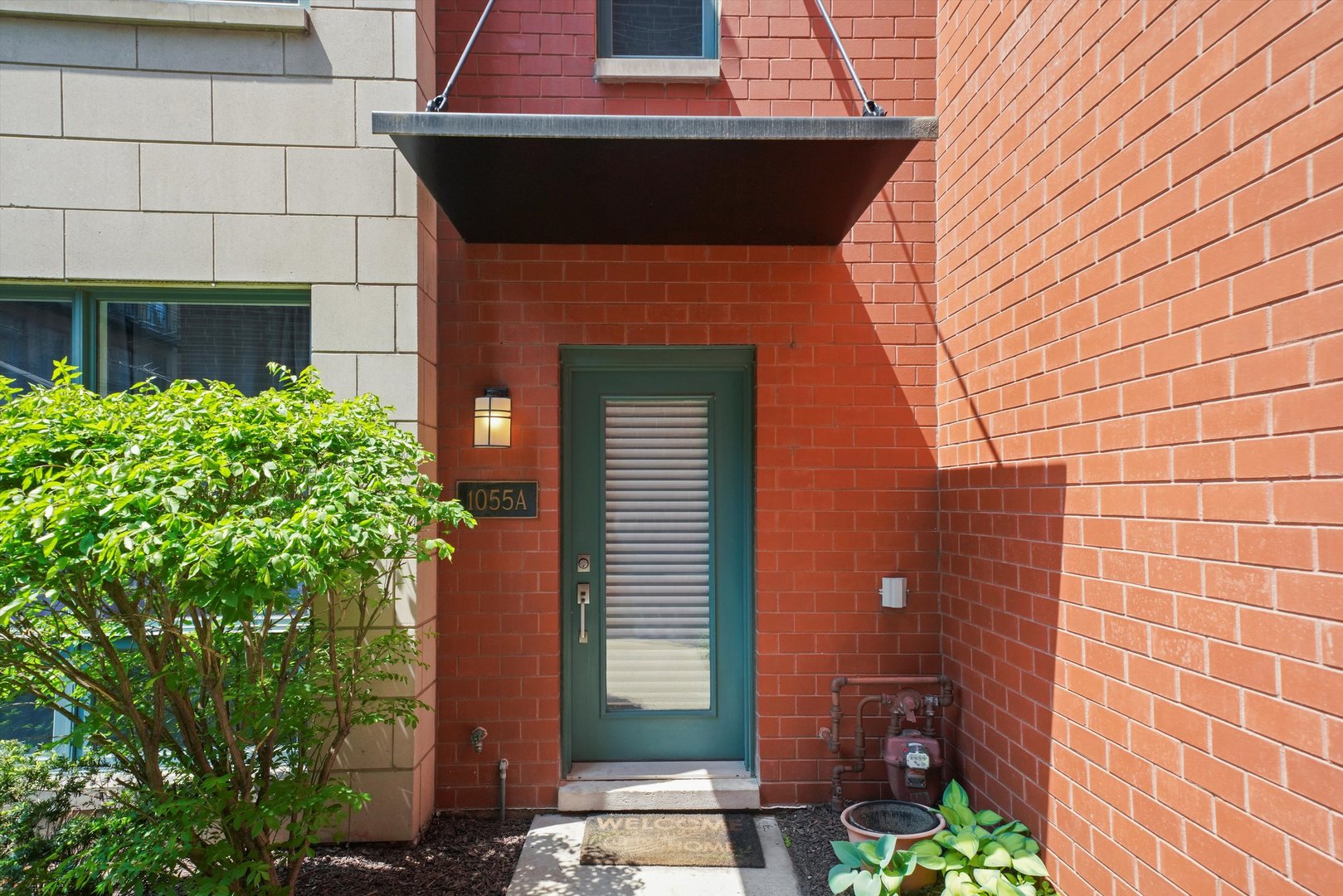 1055 West Monroe Street, Unit A Chicago, IL 60607 - Photo 28 of 28 a front view of a house with plants