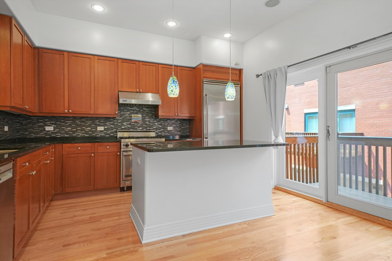 1055 West Monroe Street, Unit A Chicago, IL 60607 - Photo 5 of 28 a kitchen with stainless steel appliances granite countertop a stove a sink and a microwave
