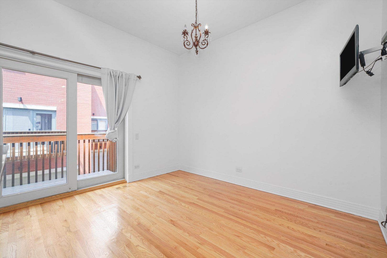 1055 West Monroe Street, Unit A Chicago, IL 60607 - Photo 6 of 28 a view of a livingroom with wooden floor and a ceiling fan