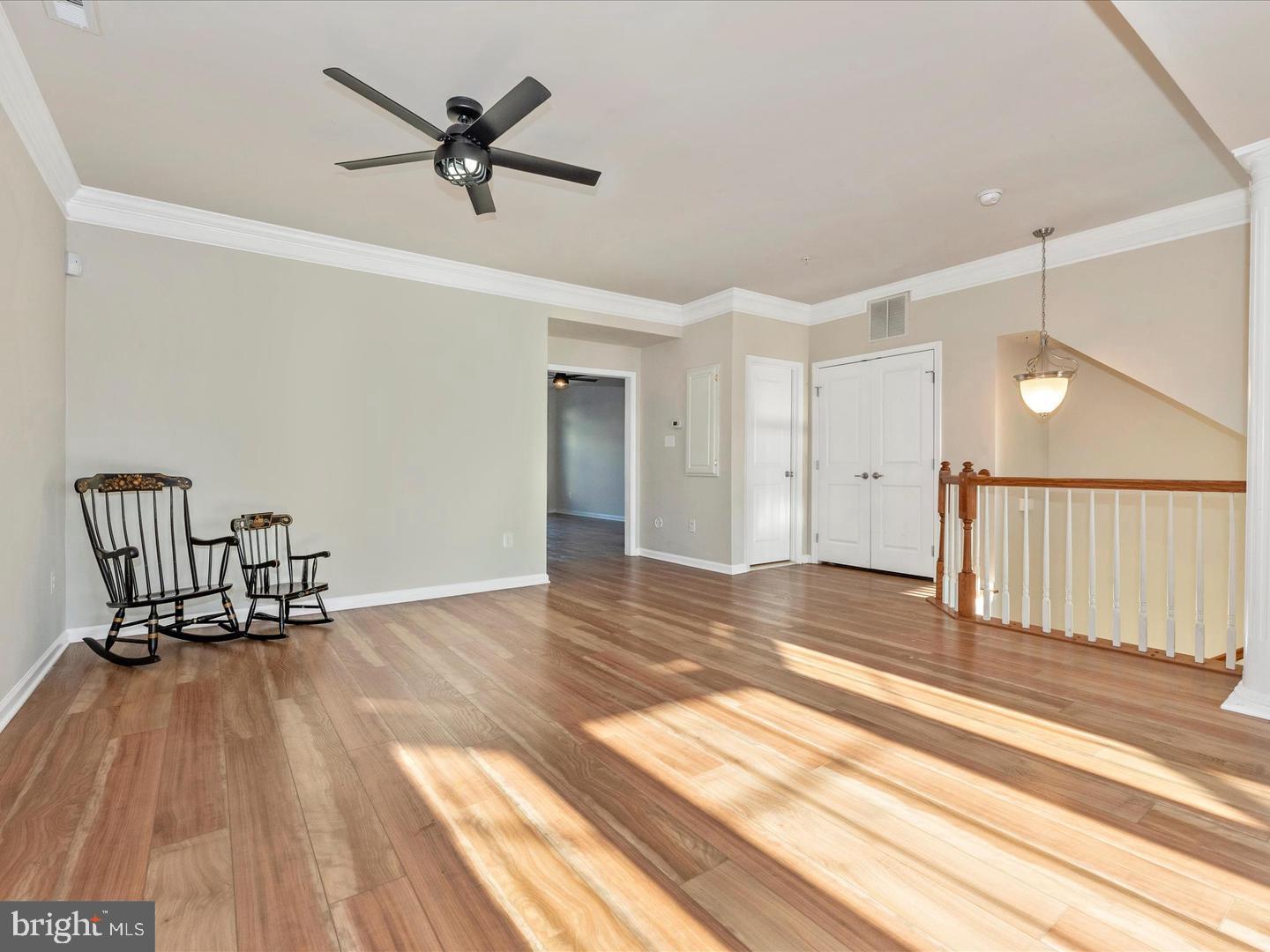 208 B Mill Pond Road Frederick, MD 21701 - Photo 6 of 45 a view of a room with wooden floor and a ceiling fan