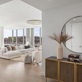 a living room with furniture fireplace and a large window