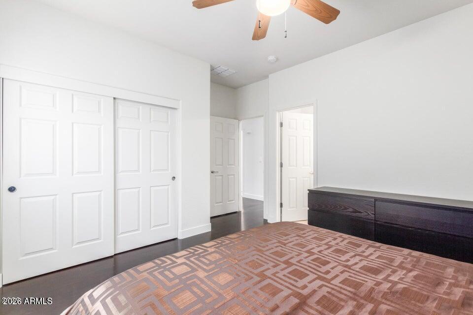 2012 West Chimney Rock Road Phoenix, AZ 85085 - Photo 25 of 61 a bedroom with a bed and a chandelier fan