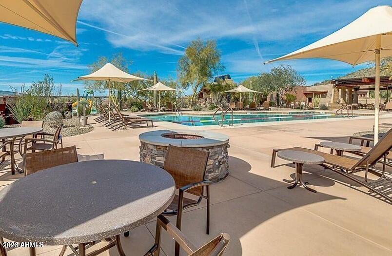 2012 West Chimney Rock Road Phoenix, AZ 85085 - Photo 43 of 61 a view of a patio with table and chairs under an umbrella