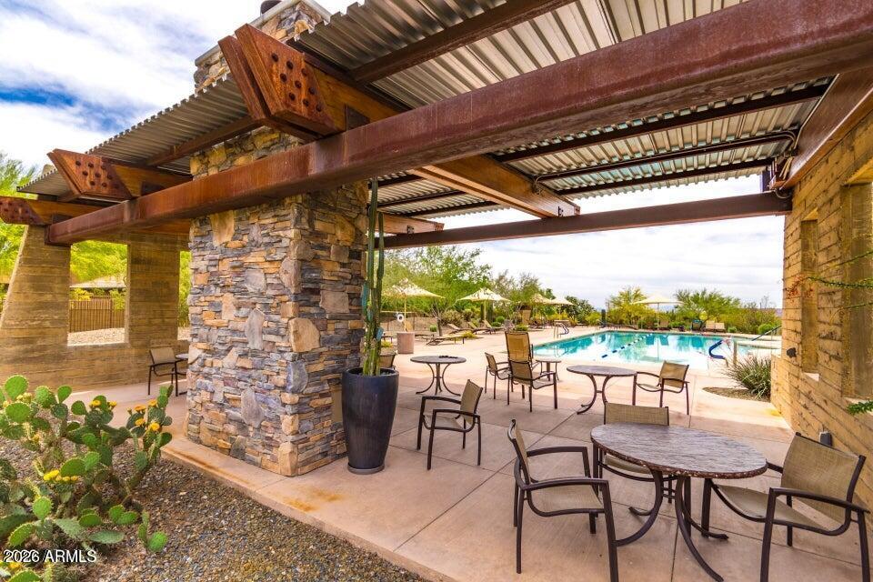 2012 West Chimney Rock Road Phoenix, AZ 85085 - Photo 55 of 61 a view of a patio with a table chairs and a backyard