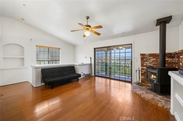 a living room with fireplace furniture and a flat screen tv