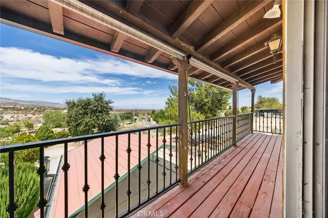 a view of a balcony with wooden floor