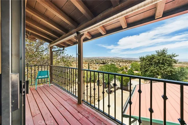 a view of balcony with wooden floor