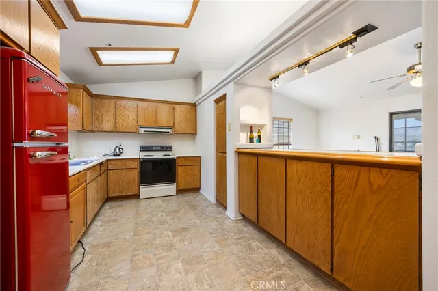 a kitchen with stainless steel appliances granite countertop a refrigerator and a stove top oven