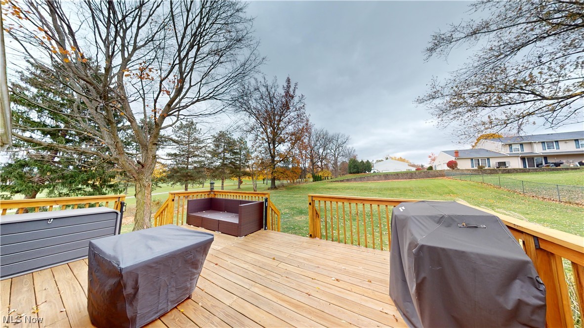 2630 Call Road Stow, OH 44224 - Photo 30 of 37 Wooden deck featuring a grill and a lawn. Over looks Fox Den golf course.