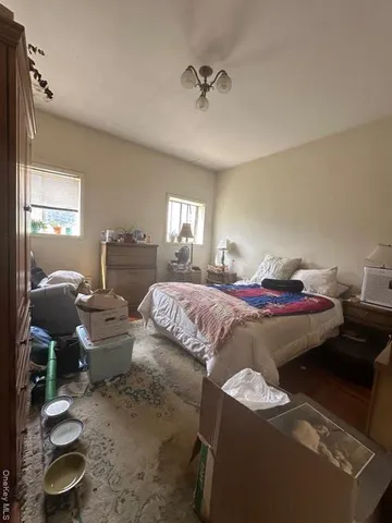 a bed room with a bed window and a chair