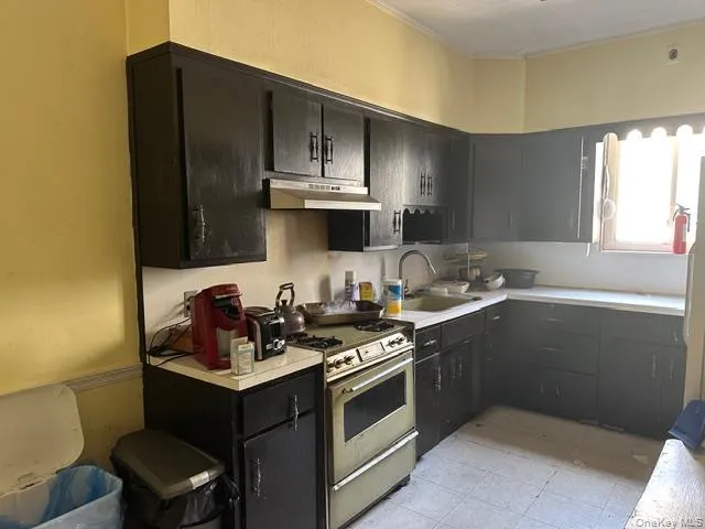 a kitchen with a sink stove and microwave