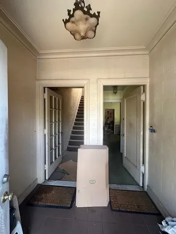 a view of a hallway with entryway wooden floor and front door