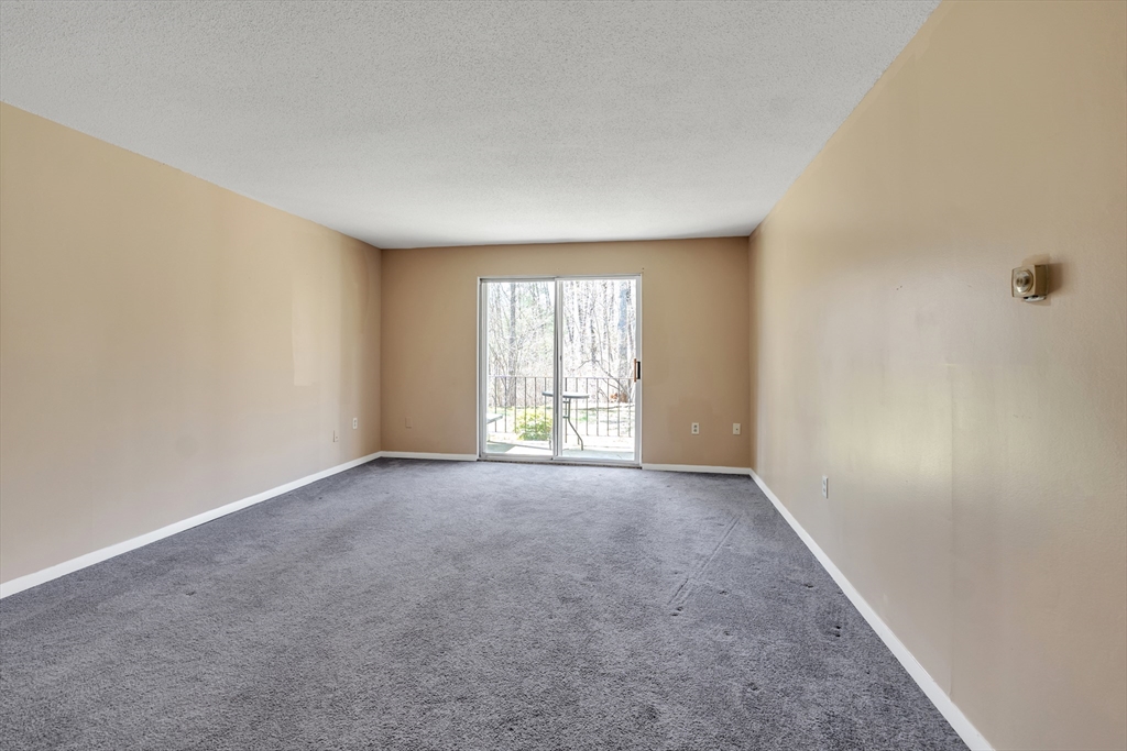 23 Shadowbrook Lane, Unit 6 Milford, MA 01757 - Photo 4 of 11 an empty room with windows