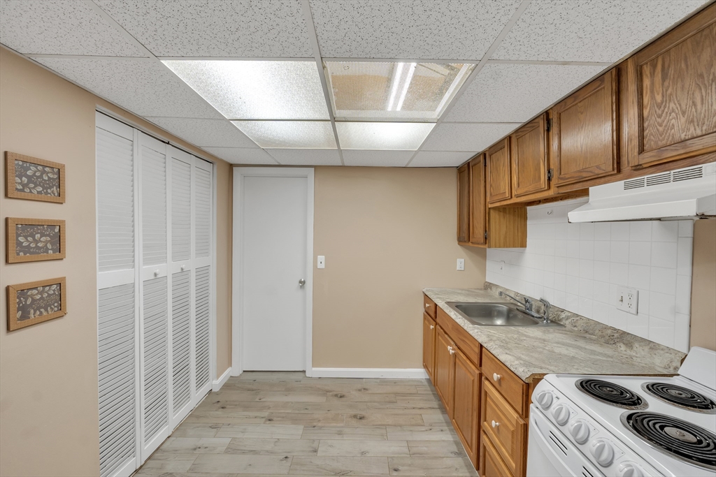 23 Shadowbrook Lane, Unit 6 Milford, MA 01757 - Photo 5 of 11 a kitchen with stainless steel appliances granite countertop a stove and a sink