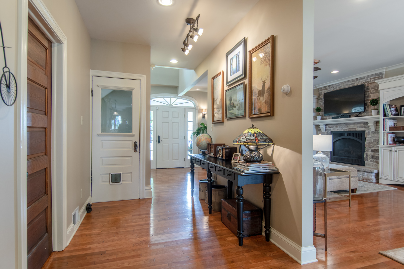 7961 Chicago Road Minooka, IL 60447 - Photo 36 of 63 a view of a dining room and livingroom with furniture wooden floor a chandelier
