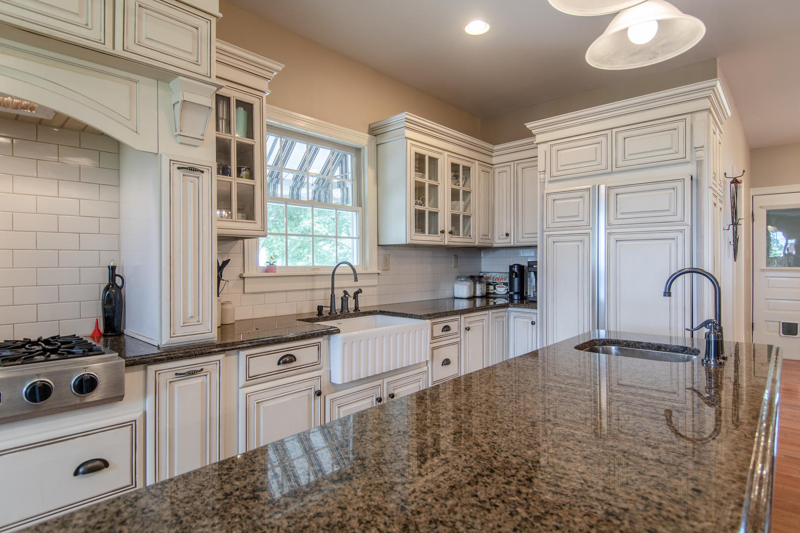 7961 Chicago Road Minooka, IL 60447 - Photo 44 of 63 a kitchen with stainless steel appliances granite countertop a stove a sink and a microwave