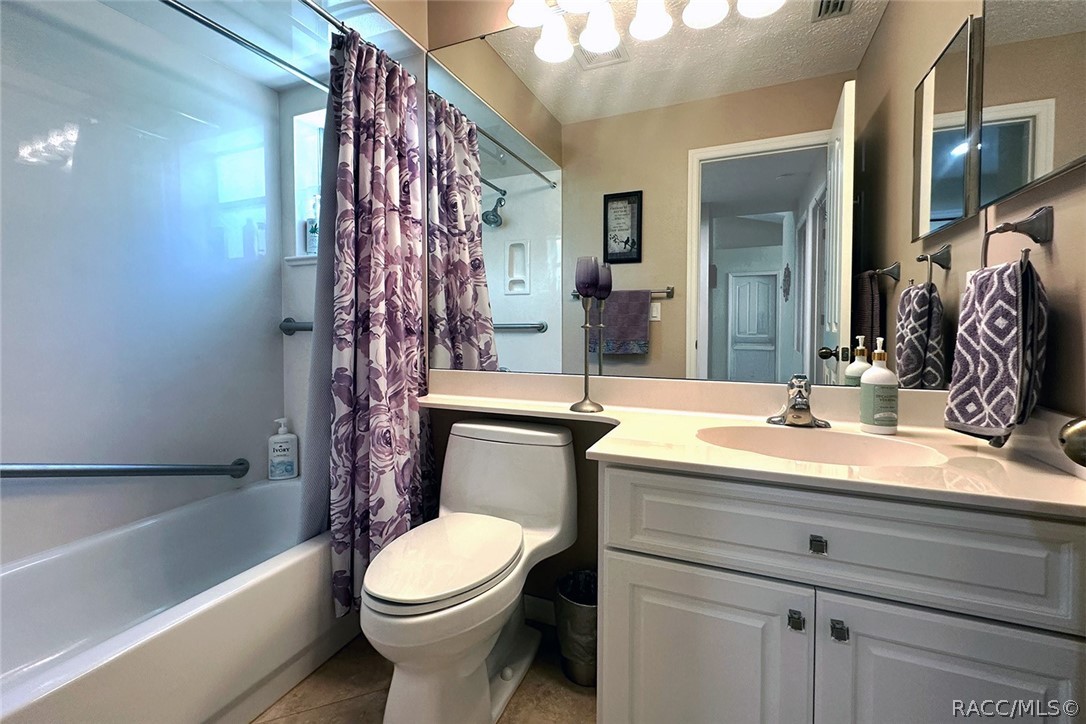 800 Balmoral Court Inverness, FL 34453 - Photo 31 of 72 a bathroom with a sink a toilet a mirror a bathtub and shower