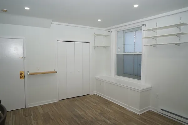 a view of walk in closet with empty racks