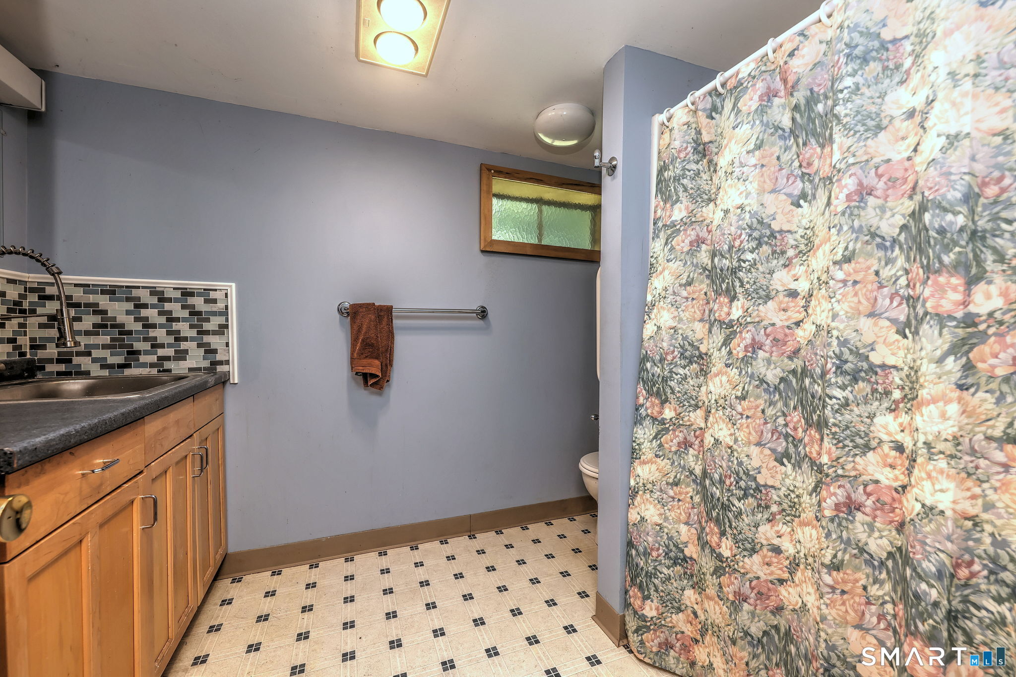 25 Mountain View Road Bethany, CT 06524 - Photo 23 of 27 The lower level bathroom features a stall shower and vinyl floor.
