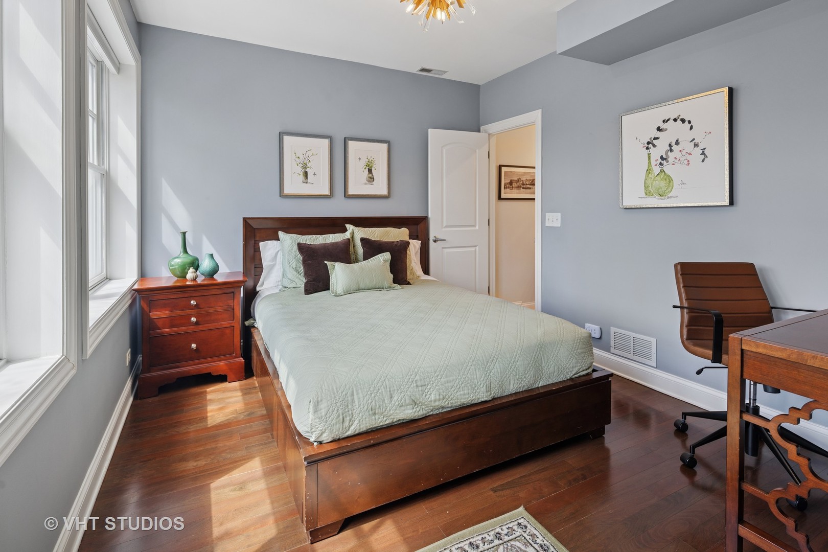 1608 West Grace Street Chicago, IL 60613 - Photo 17 of 25 a bed sitting in a bedroom next to a window